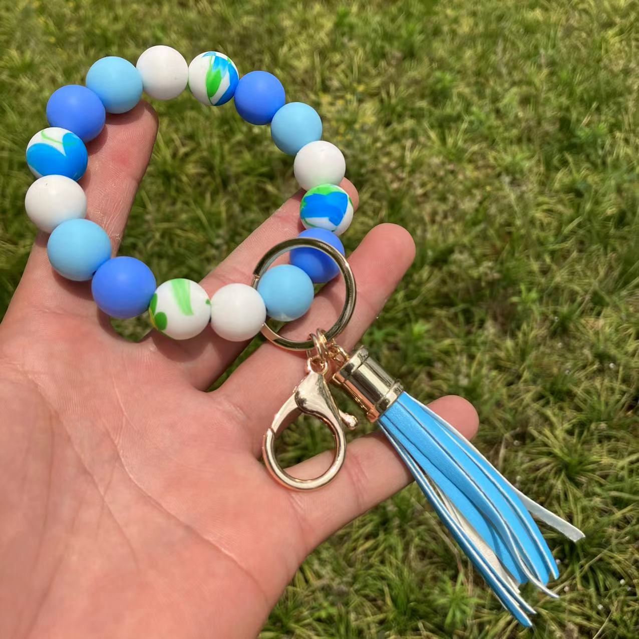 Comercio al por mayor leopardo girasol borla de silicona con cuentas llavero de muñeca